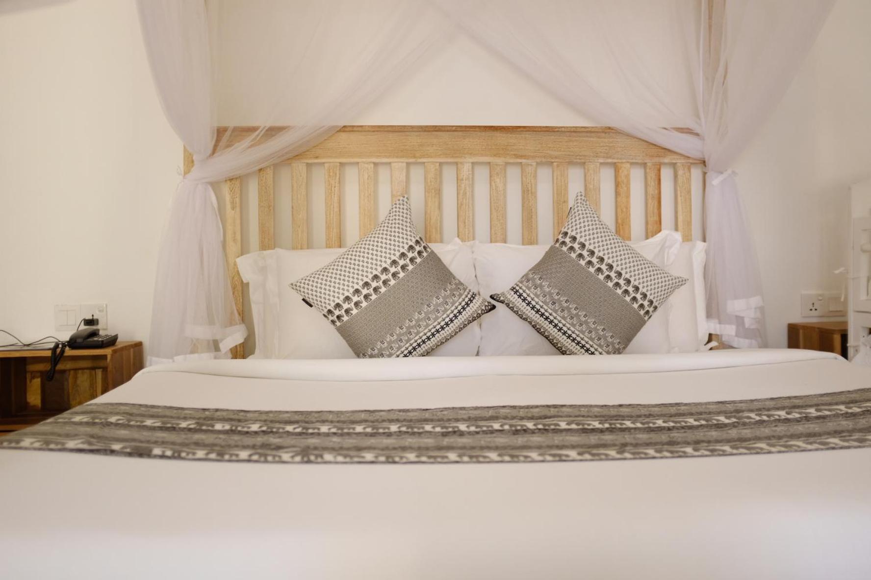 Nivadoo Resort Sigiriya Pokoj fotografie A bed with a mosquito net